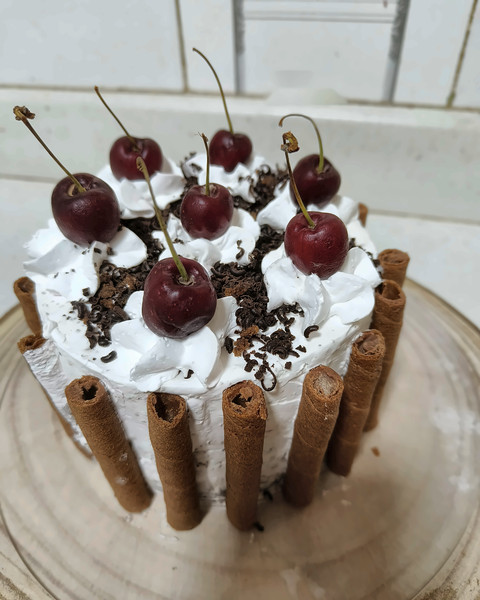 Black Forest cake with cherries and wafer rolls