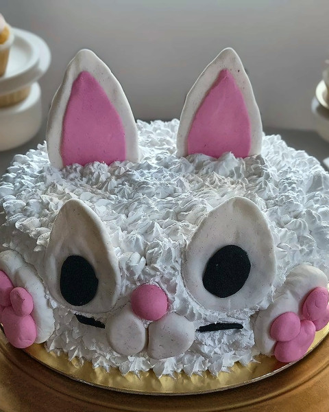 White bunny cake with fondant ears and face