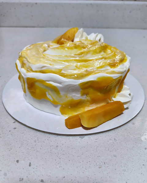 Mango cream cake with mango and cream swirls