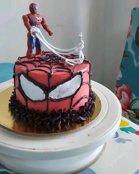 Spiderman face cake in red and black cream